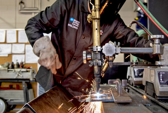 Student using welding machine